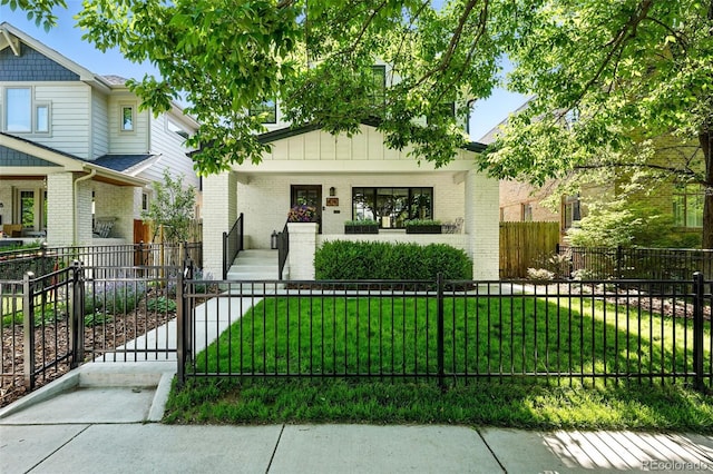 474 S Vine St, Denver, CO 80209 - craftsman inspired home featuring covered porch, brick siding, a fenced front yard, and a gate