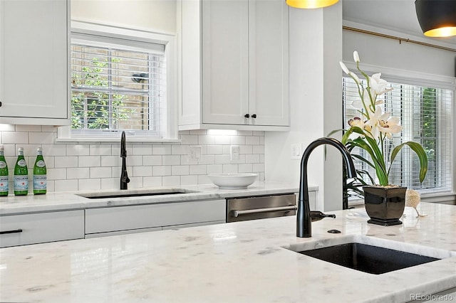 474 S Vine St, Denver, CO 80209 - kitchen with white cabinets, backsplash, and light stone counters