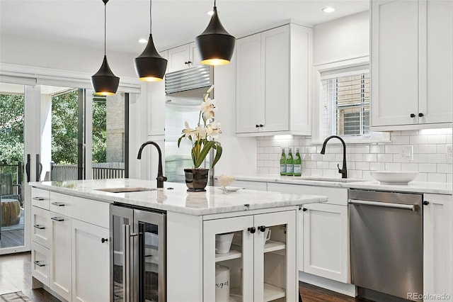 474 S Vine St, Denver, CO 80209 - kitchen with wine cooler, stainless steel dishwasher, plenty of natural light, white cabinetry, and recessed lighting