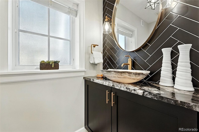 474 S Vine St, Denver, CO 80209 - bathroom featuring tasteful backsplash and vanity