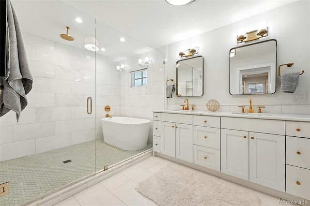 474 S Vine St, Denver, CO 80209 - bathroom featuring a stall shower, double vanity, a freestanding bath, tile patterned floors, and recessed lighting