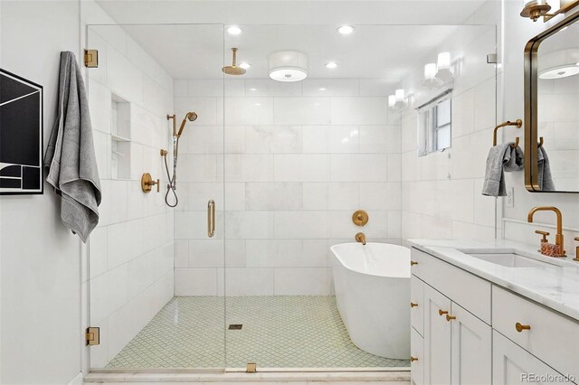 474 S Vine St, Denver, CO 80209 - bathroom featuring a stall shower, vanity, a soaking tub, and recessed lighting