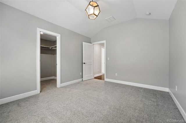 474 S Vine St, Denver, CO 80209 - unfurnished bedroom featuring carpet, lofted ceiling, a walk in closet, and a closet