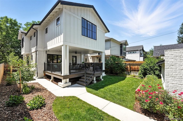 474 S Vine St, Denver, CO 80209 - view of front of home featuring board and batten siding, a ceiling fan, and a fenced backyard