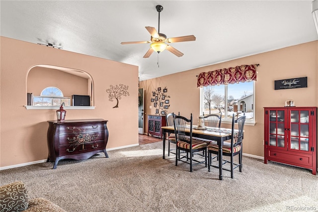 dining area with carpet and ceiling fan