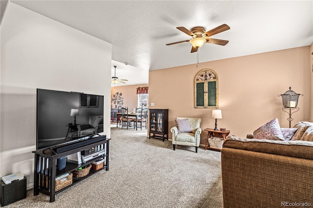 living room featuring a textured ceiling, ceiling fan, and carpet