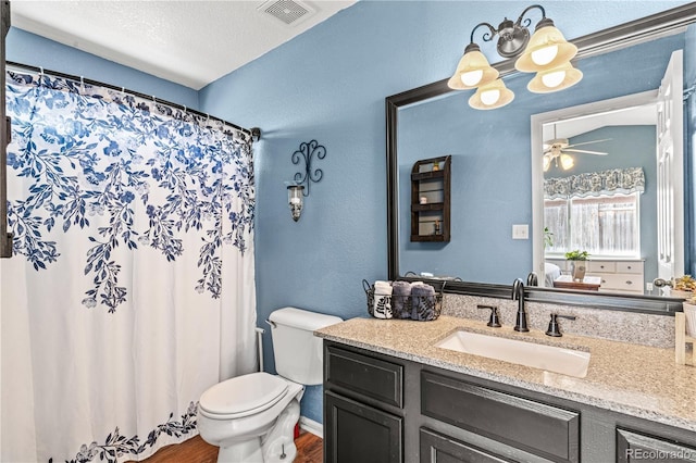 bathroom with hardwood / wood-style flooring, ceiling fan, vanity, a textured ceiling, and toilet