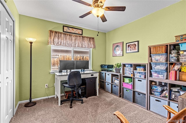 office space with ceiling fan and carpet