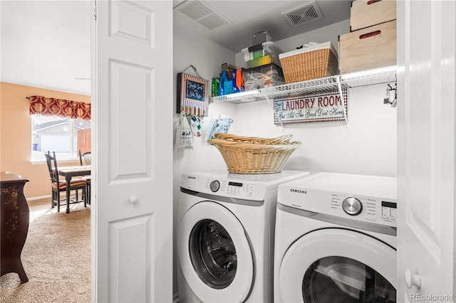 laundry area with carpet flooring and washing machine and dryer