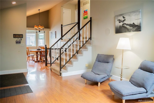 7961 Jared Way, Littleton, CO 80125 - stairs with a chandelier, wood finished floors, and vaulted ceiling