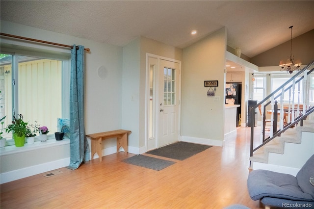 7961 Jared Way, Littleton, CO 80125 - entryway with wood finished floors, a chandelier, stairway, lofted ceiling, and recessed lighting