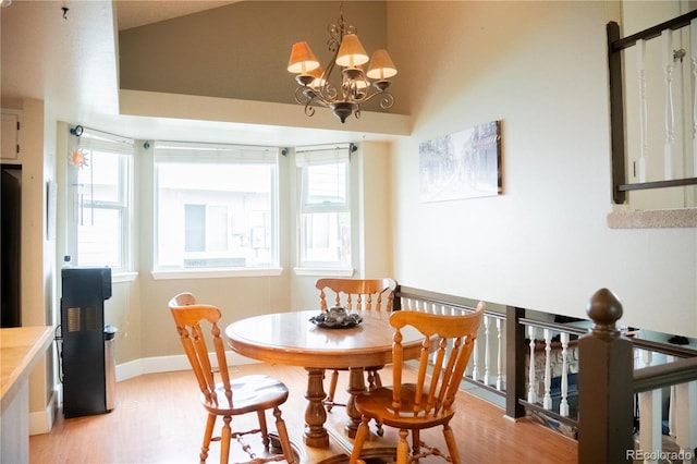 7961 Jared Way, Littleton, CO 80125 - dining space featuring light wood-style flooring, a chandelier, and high vaulted ceiling