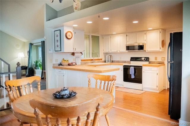 7961 Jared Way, Littleton, CO 80125 - kitchen featuring electric stove, stainless steel microwave, freestanding refrigerator, butcher block countertops, and white cabinetry
