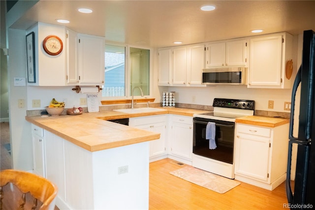 7961 Jared Way, Littleton, CO 80125 - kitchen with range with electric stovetop, stainless steel microwave, a peninsula, white cabinetry, and light countertops