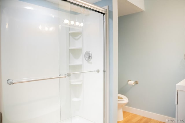 7961 Jared Way, Littleton, CO 80125 - full bathroom with a shower stall, vanity, and wood finished floors