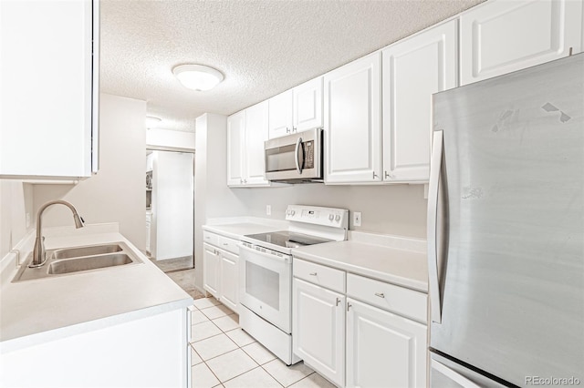 2225 Buchtel Blvd Unit 1005, Denver, CO 80210 - kitchen featuring stainless steel appliances, a sink, white cabinets, light countertops, and a textured ceiling