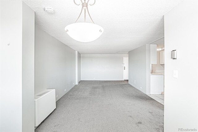 2225 Buchtel Blvd Unit 1005, Denver, CO 80210 - hallway with light colored carpet and a textured ceiling