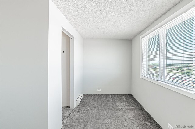 2225 Buchtel Blvd Unit 1005, Denver, CO 80210 - spare room featuring a baseboard radiator, carpet flooring, and a textured ceiling
