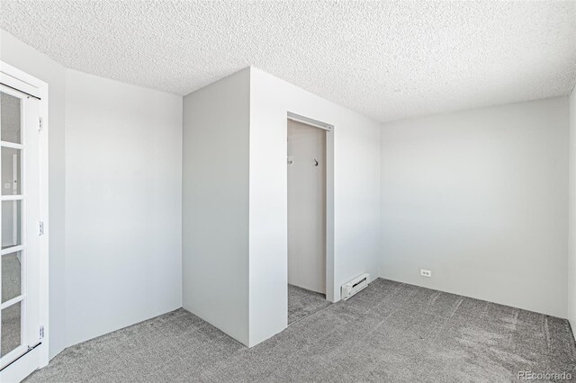 2225 Buchtel Blvd Unit 1005, Denver, CO 80210 - unfurnished bedroom with carpet floors, baseboard heating, a textured ceiling, and a closet