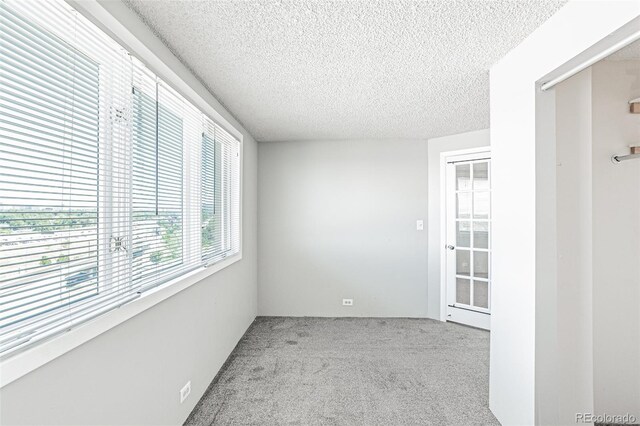 2225 Buchtel Blvd Unit 1005, Denver, CO 80210 - empty room featuring carpet flooring and a textured ceiling