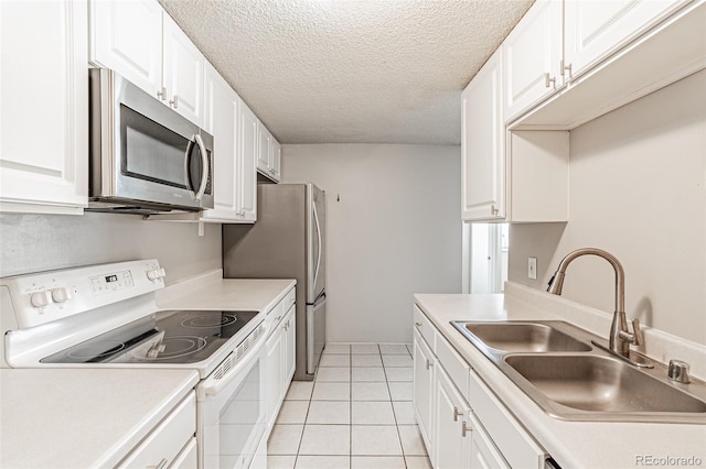2225 Buchtel Blvd Unit 1005, Denver, CO 80210 - kitchen with stainless steel appliances, a sink, a textured ceiling, white cabinets, and light tile patterned floors