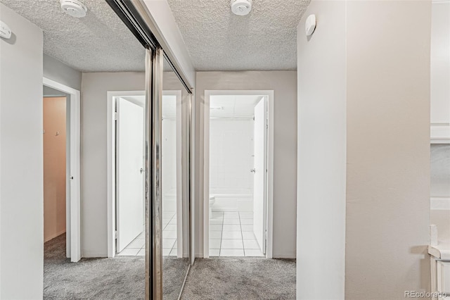 2225 Buchtel Blvd Unit 1005, Denver, CO 80210 - hall with carpet floors and a textured ceiling