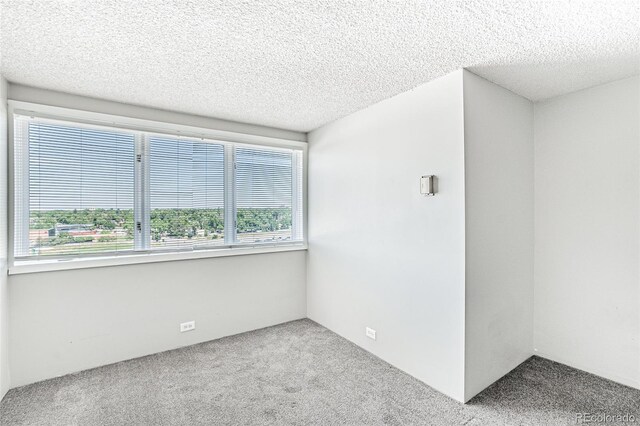 2225 Buchtel Blvd Unit 1005, Denver, CO 80210 - carpeted empty room featuring healthy amount of natural light and a textured ceiling
