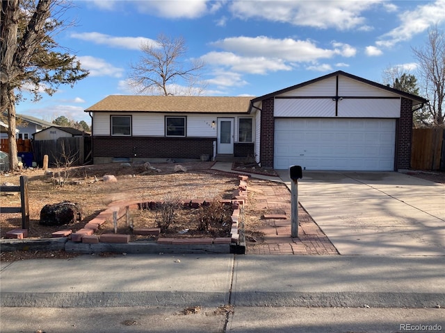 single story home with concrete driveway, brick siding, fence, and an attached garage