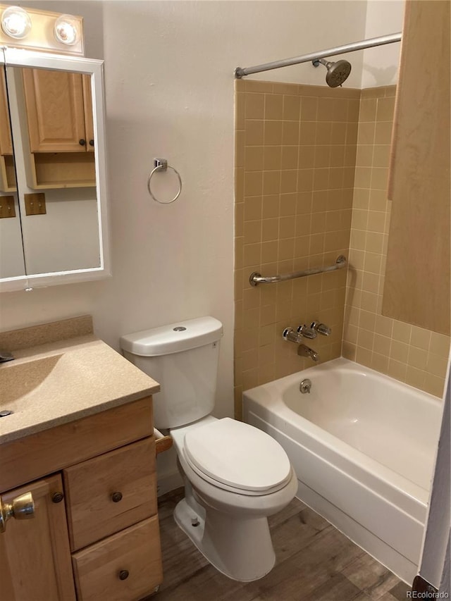 full bath with toilet, tub / shower combination, wood finished floors, and vanity