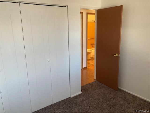 unfurnished bedroom with carpet floors and a closet