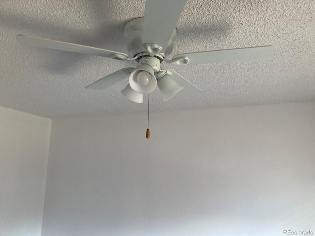 details featuring a textured ceiling and a ceiling fan