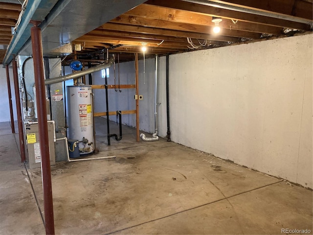 unfinished below grade area featuring water heater