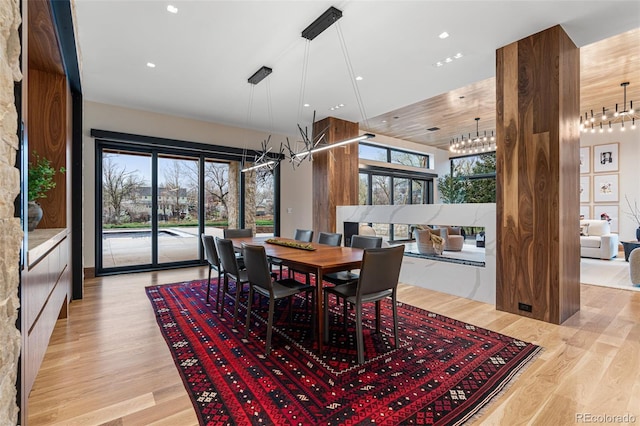 dining area featuring light wood-type flooring and a chandelier