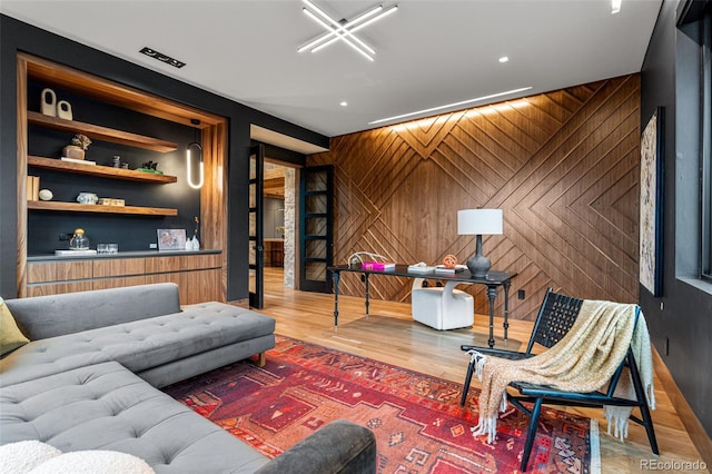 living room featuring wood-type flooring and wooden walls