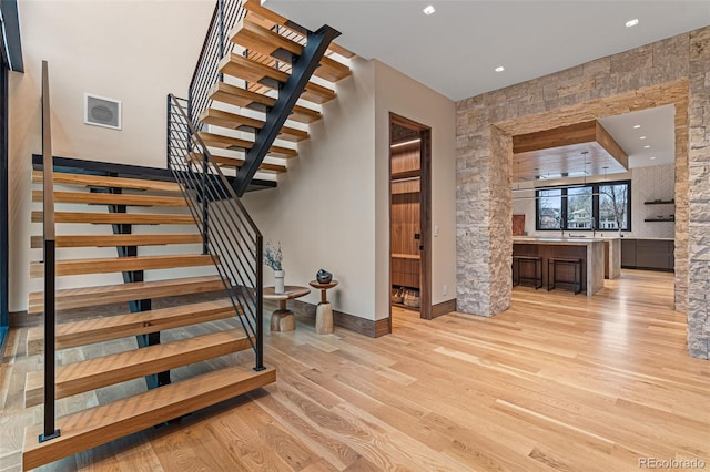 staircase featuring hardwood / wood-style floors