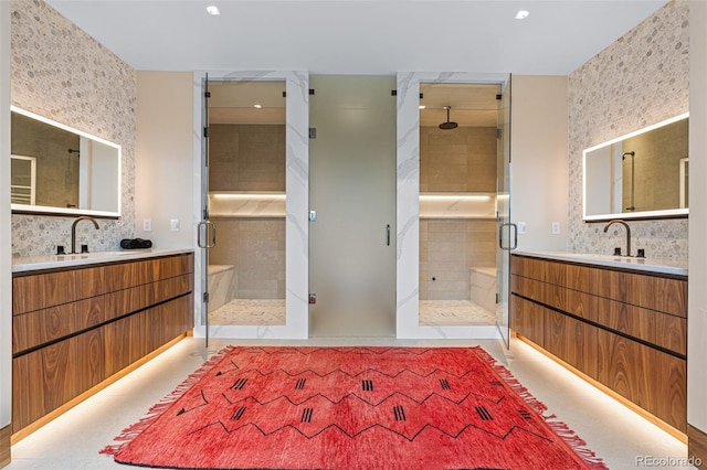 bathroom featuring a shower with door and vanity