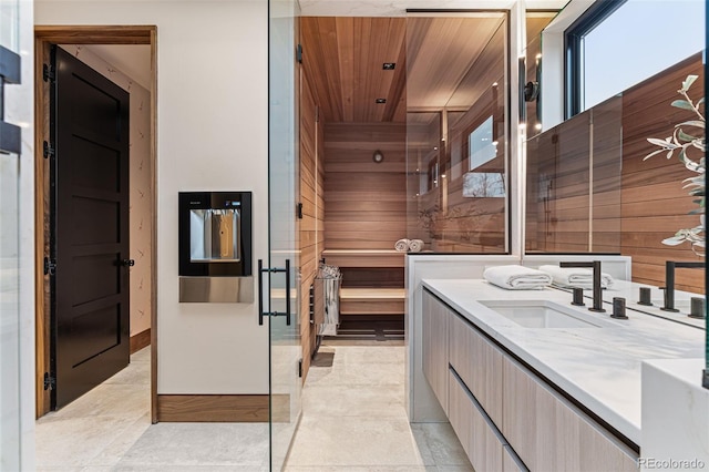 bathroom featuring wood walls, vanity, and wooden ceiling