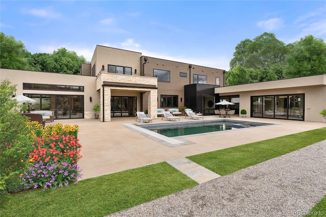 rear view of house featuring a patio area, an outdoor hangout area, and a balcony