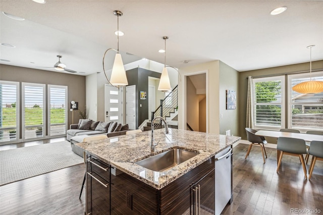 9244 E 37th Ave, Denver, CO 80238 - kitchen with stainless steel dishwasher, pendant lighting, dark brown cabinetry, dark wood finished floors, and recessed lighting