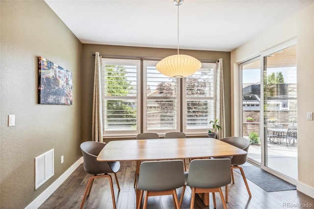 9244 E 37th Ave, Denver, CO 80238 - dining space featuring hardwood / wood-style flooring, plenty of natural light, and a textured wall