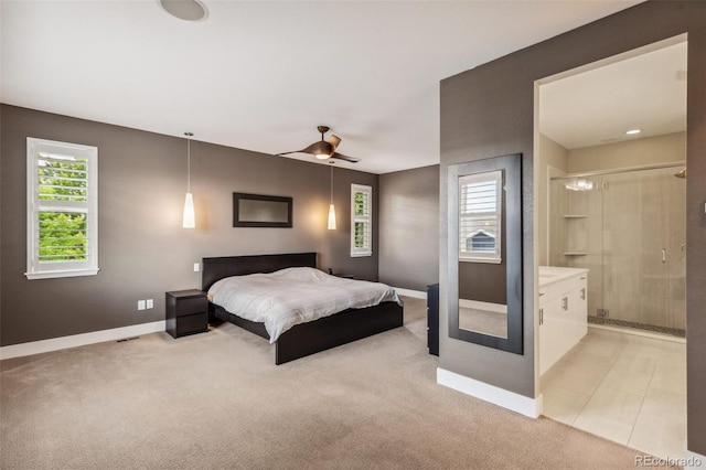 9244 E 37th Ave, Denver, CO 80238 - bedroom featuring multiple windows, light carpet, connected bathroom, and a ceiling fan