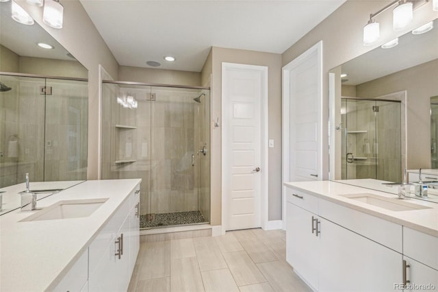 9244 E 37th Ave, Denver, CO 80238 - full bathroom featuring two vanities, a stall shower, and recessed lighting
