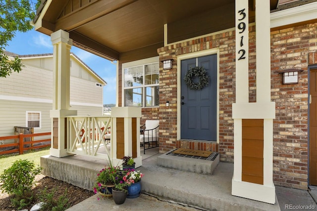 3912 Miners Candle Pl, Castle Rock, CO 80109 - view of exterior entry featuring a porch and brick siding