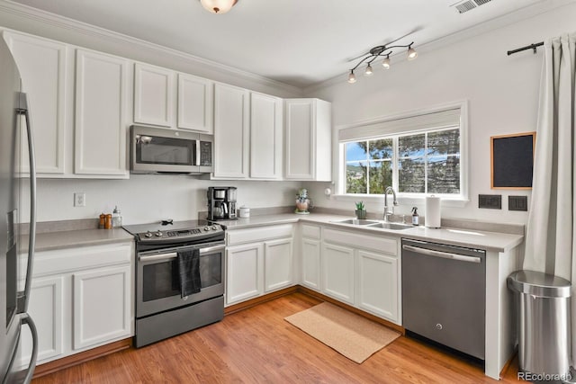 3912 Miners Candle Pl, Castle Rock, CO 80109 - kitchen featuring appliances with stainless steel finishes, white cabinetry, and ornamental molding