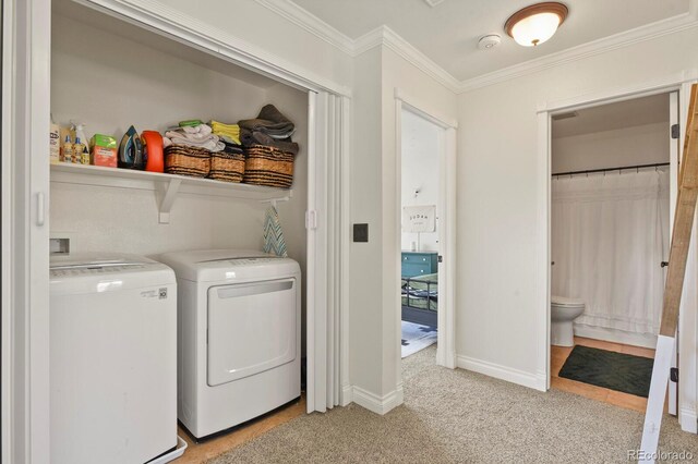 3912 Miners Candle Pl, Castle Rock, CO 80109 - washroom with washing machine and clothes dryer, ornamental molding, and light carpet