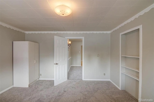 unfurnished room with carpet floors and crown molding