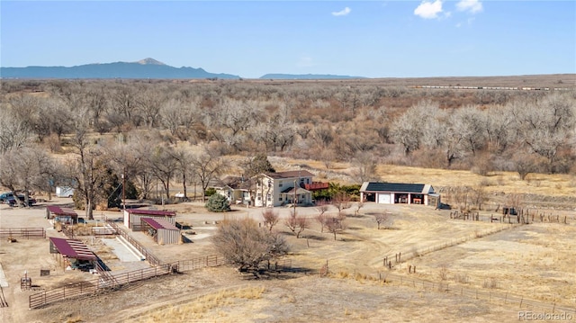 birds eye view of property with a mountain view and a rural view