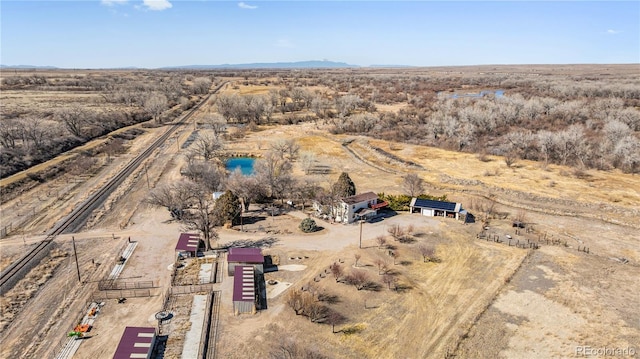 birds eye view of property with a desert view and a rural view