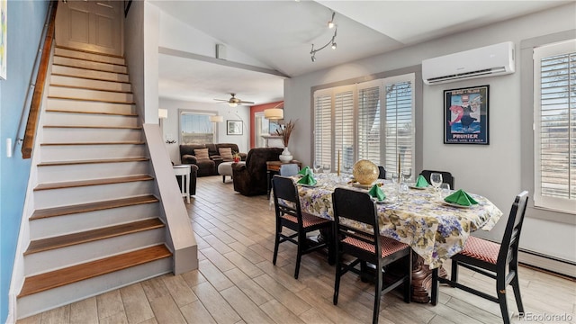 dining area featuring stairs, a wealth of natural light, a wall mounted air conditioner, and wood tiled floor