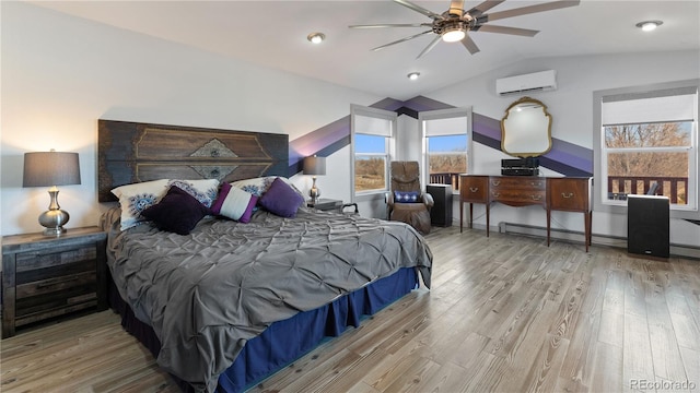 bedroom with a wall unit AC, lofted ceiling, baseboard heating, wood finished floors, and baseboards